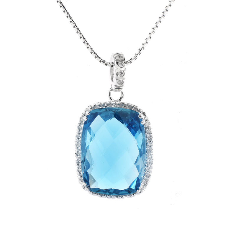 Criss Cross Cut London Blue Topaz, Diamond and 14 Karat White Gold Pendant Necklace. Topaz measures 18mm x 13mm. 