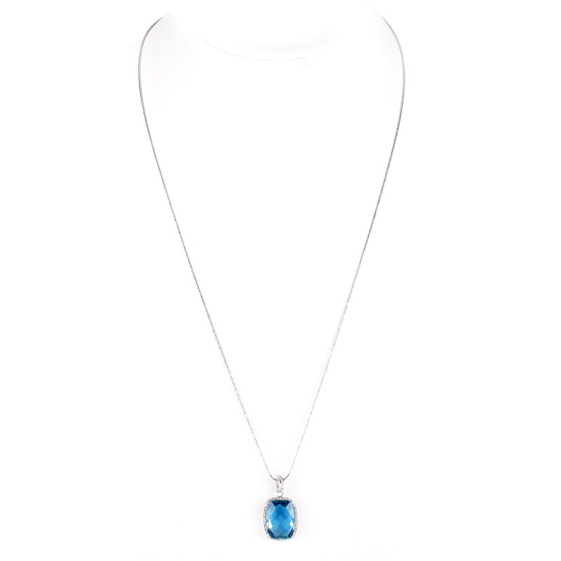 Criss Cross Cut London Blue Topaz, Diamond and 14 Karat White Gold Pendant Necklace. Topaz measures 18mm x 13mm. 