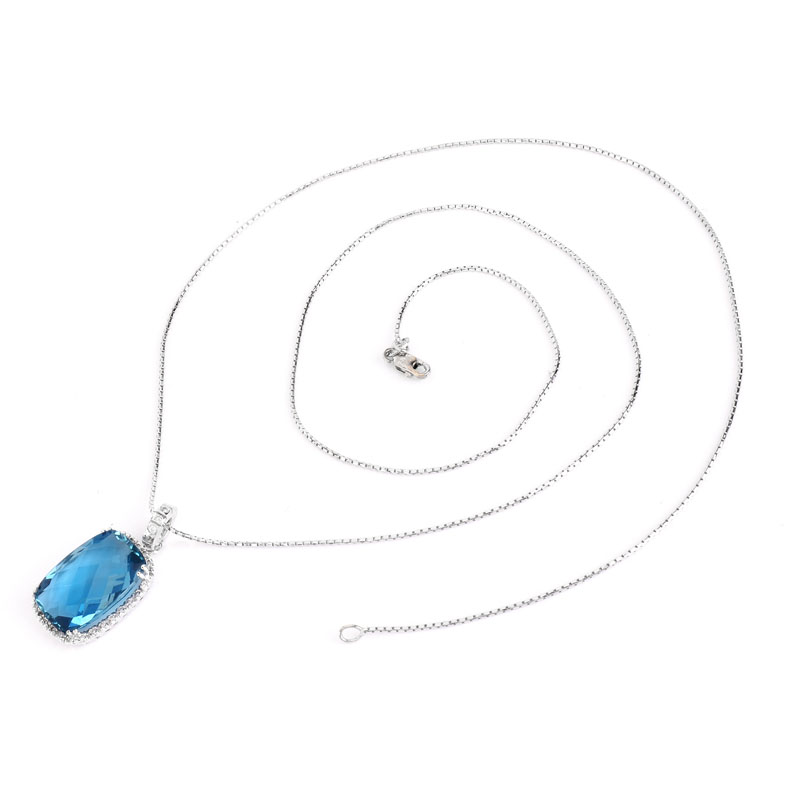 Criss Cross Cut London Blue Topaz, Diamond and 14 Karat White Gold Pendant Necklace. Topaz measures 18mm x 13mm. 