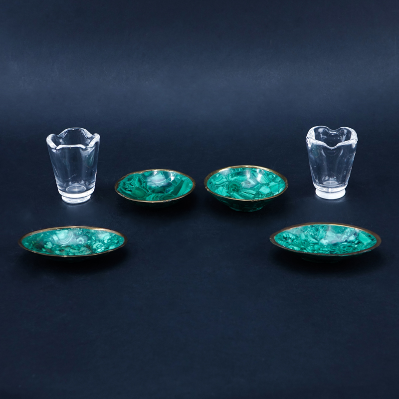 Six (6) Piece Assembled Smoking Set. Includes 4 brass mounted malachite ashtrays and 2 Steuben crystal urns.