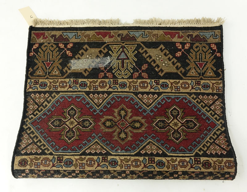 Black Oriental Rug. Numbered on underside. Stains to fringes, dirty. Measures 61" H x 38" W.