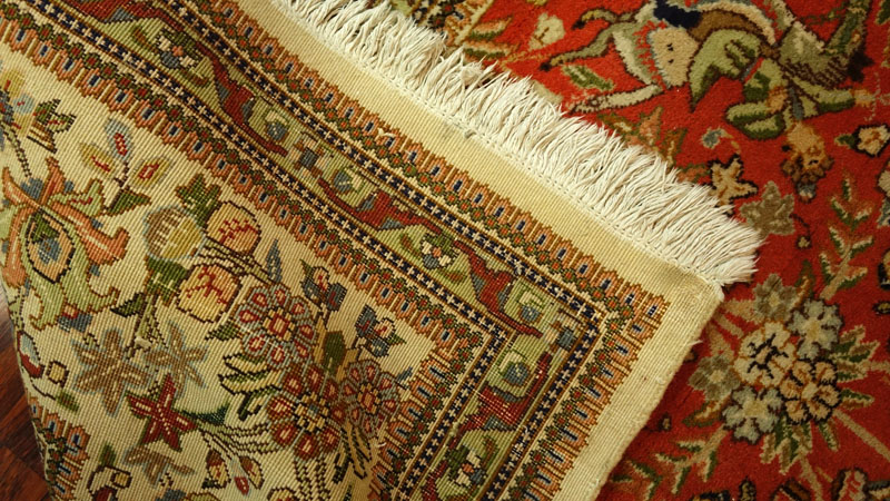 Large Semi Antique Karastan Persian Rug. Floral motif with hunting scenes. Discoloration, dirty, wear to fringes, loss to corner. 