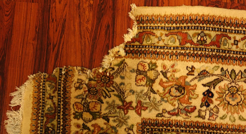 Large Semi Antique Karastan Persian Rug. Floral motif with hunting scenes. Discoloration, dirty, wear to fringes, loss to corner. 