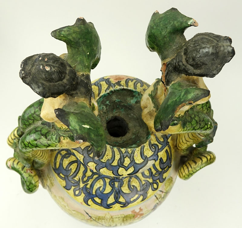 19th Century Italian Faience Majolica Renaissance Style Pottery Urn. Decorated with winged nude figural handles above figural idols, yellow ground with intertwining patterns. 