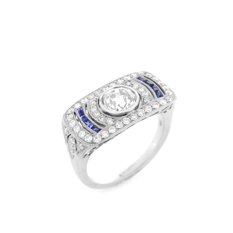 Art Deco style Approx. 1.01 Carat TW Diamond, .14 Carat Sapphire and Platinum Ring set in the Center with a .87 Carat Round Brilliant Cut Diamond.