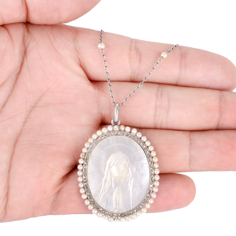 Antique Circa 1918 Platinum, Yellow Gold, Carved Mother of Pearl, Micro Pearl and Diamond Blessed Virgin / Madonna Pendant Necklace.