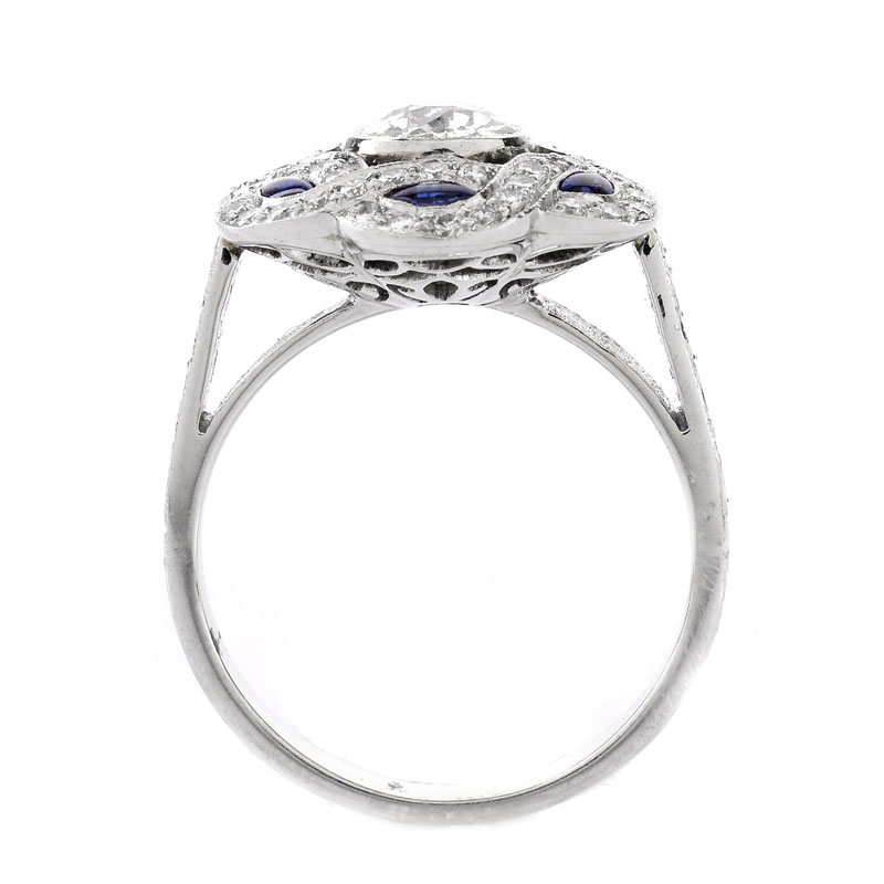 Art Deco style Diamond, Sapphire and Platinum Ring set in the Center with .66 Carat Round Brilliant Cut Diamond.