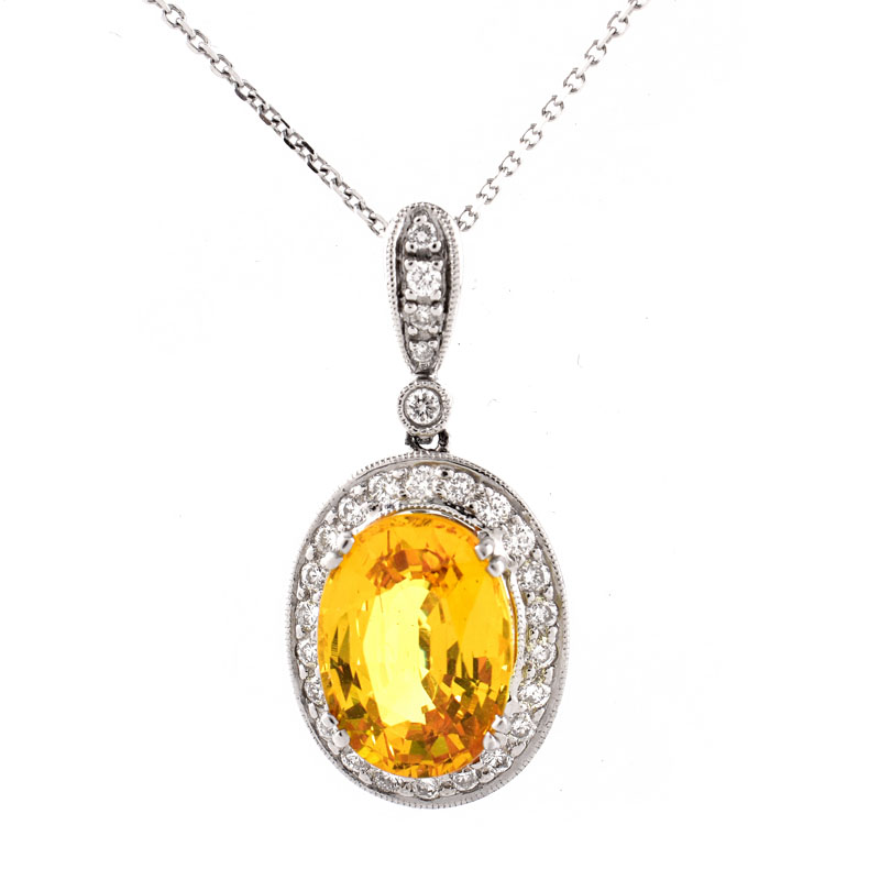 Approx. 6.52 Carat Oval Cut Yellow Sapphire, .65 Carat Pave Set Diamond and 18 Karat White Gold Pendant with 14 Karat White Gold Chain.