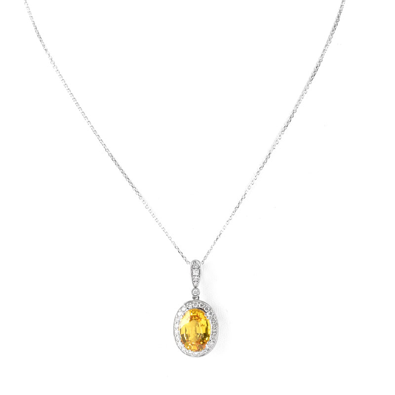 Approx. 6.52 Carat Oval Cut Yellow Sapphire, .65 Carat Pave Set Diamond and 18 Karat White Gold Pendant with 14 Karat White Gold Chain.