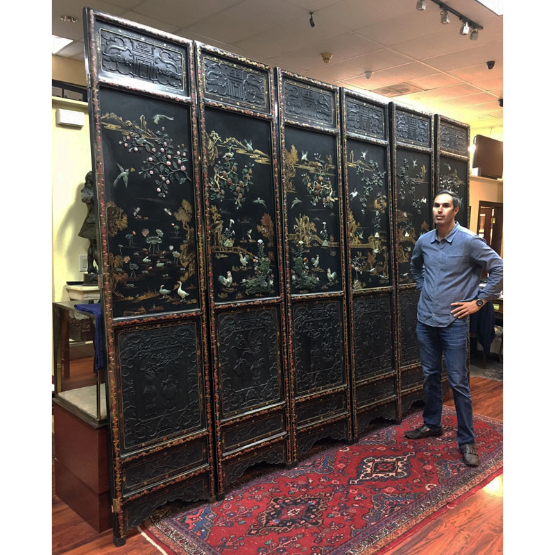 Important Palace-Size Late 19th or Early 20th Century Chinese Black Lacquer Wood, Deep Relief Carved Six Panel Screen Inlaid with Jade, Carnelian, and Rose Quartz. 