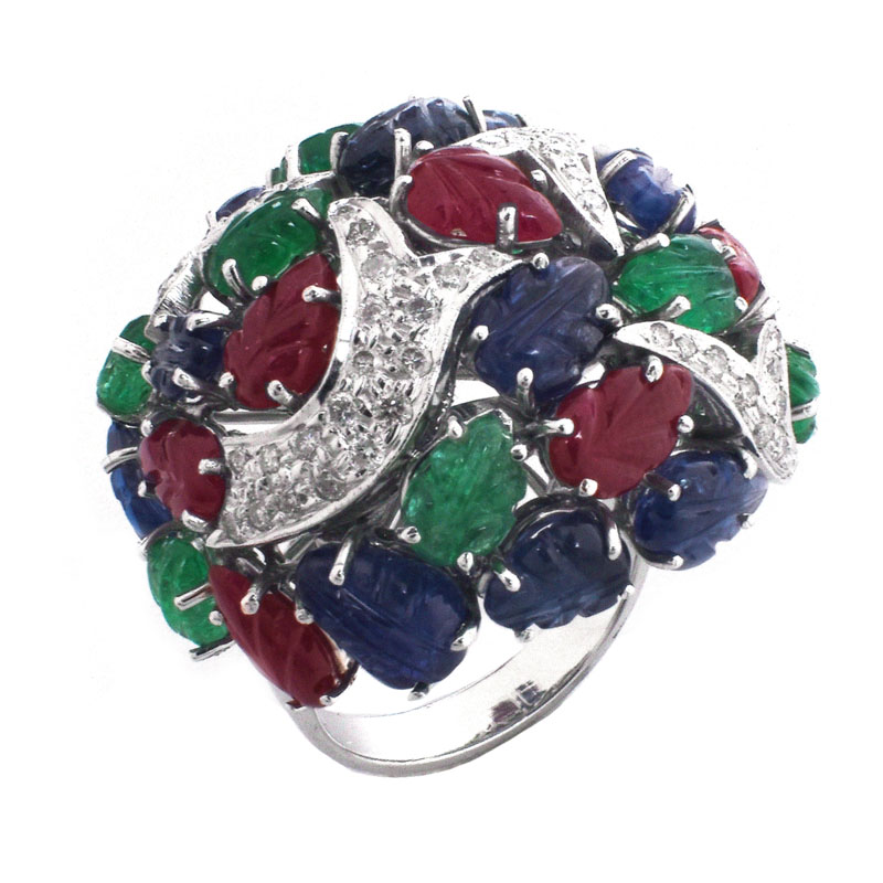 Cartier style Approx. 18.50 Carat Carved Emerald, Ruby and Sapphire, .85 Carat Diamond and 18 Karat White Gold Tutti Frutti Ring. 