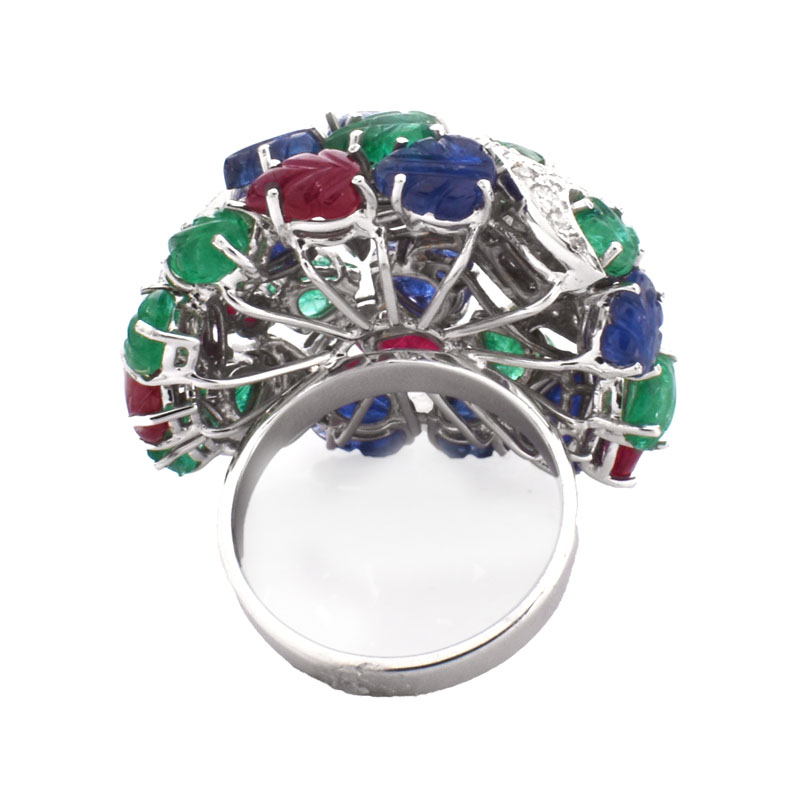 Cartier style Approx. 18.50 Carat Carved Emerald, Ruby and Sapphire, .85 Carat Diamond and 18 Karat White Gold Tutti Frutti Ring. 