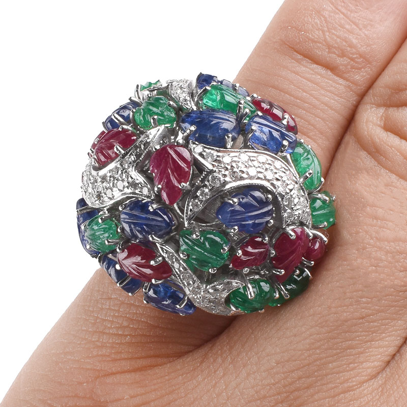 Cartier style Approx. 18.50 Carat Carved Emerald, Ruby and Sapphire, .85 Carat Diamond and 18 Karat White Gold Tutti Frutti Ring. 