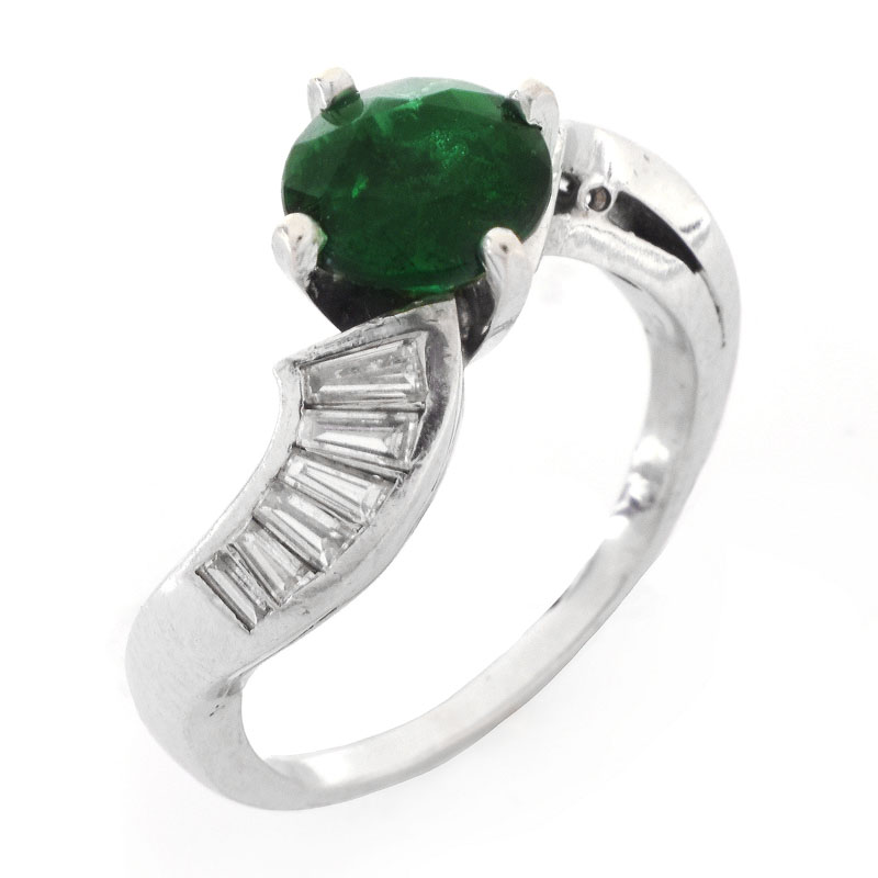 Vintage Circa 1940s Approx. 1.60 Carat Colombian Round Cut Emerald, 1.0 Carat Baguette Cut Diamond and Platinum Ring. Emerald with vivid color.