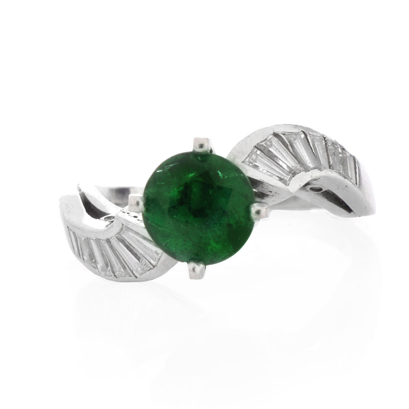 Vintage Circa 1940s Approx. 1.60 Carat Colombian Round Cut Emerald, 1.0 Carat Baguette Cut Diamond and Platinum Ring. Emerald with vivid color.