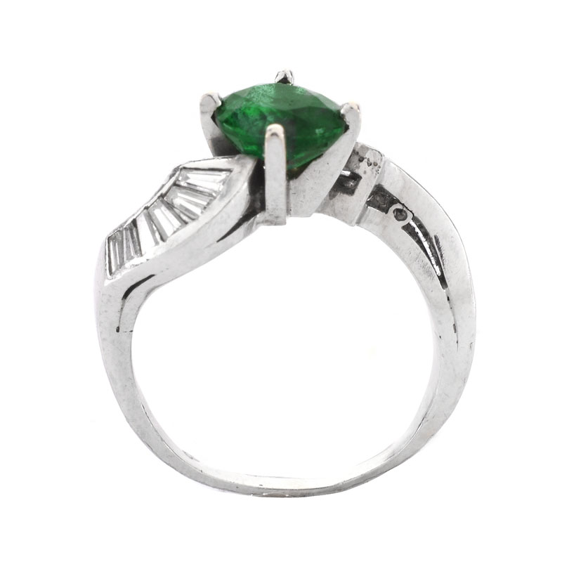 Vintage Circa 1940s Approx. 1.60 Carat Colombian Round Cut Emerald, 1.0 Carat Baguette Cut Diamond and Platinum Ring. Emerald with vivid color.