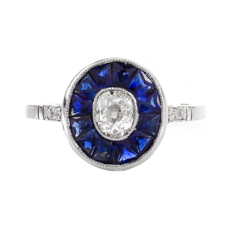 Art Deco Circa 1920s Approx. .65 Carat Old European Cut Diamond, Calibre Cut Sapphire and Platinum Ring. 