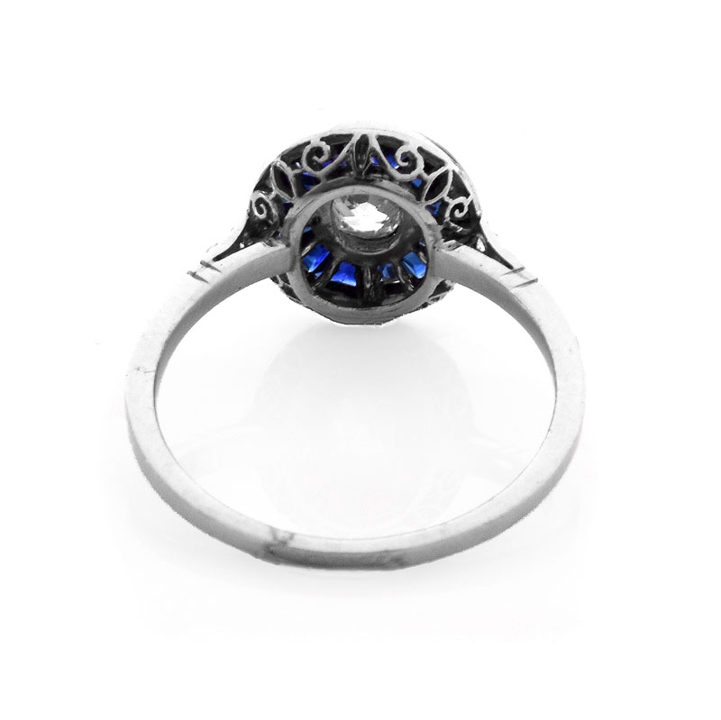 Art Deco Circa 1920s Approx. .65 Carat Old European Cut Diamond, Calibre Cut Sapphire and Platinum Ring. 