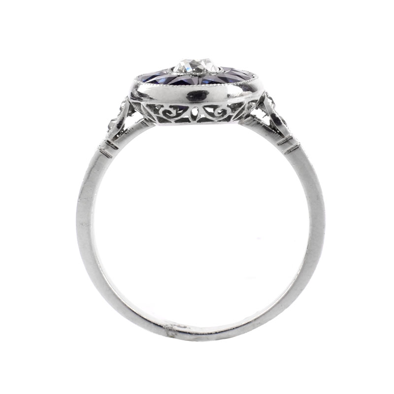 Art Deco Circa 1920s Approx. .65 Carat Old European Cut Diamond, Calibre Cut Sapphire and Platinum Ring. 