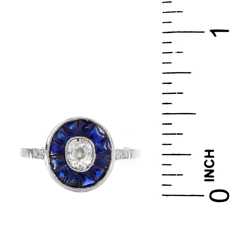 Art Deco Circa 1920s Approx. .65 Carat Old European Cut Diamond, Calibre Cut Sapphire and Platinum Ring. 