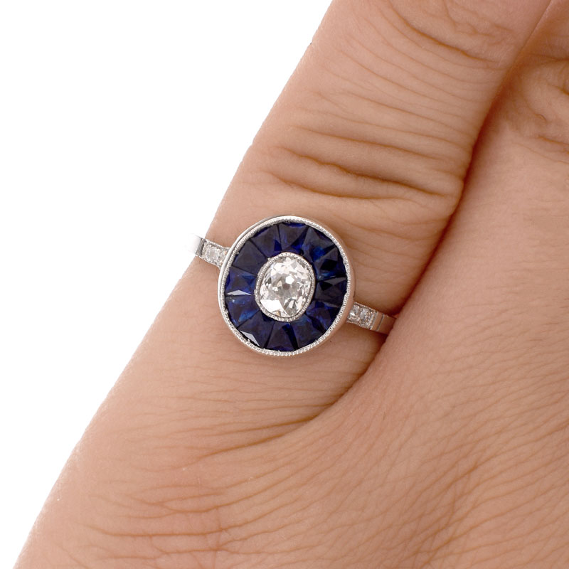 Art Deco Circa 1920s Approx. .65 Carat Old European Cut Diamond, Calibre Cut Sapphire and Platinum Ring. 