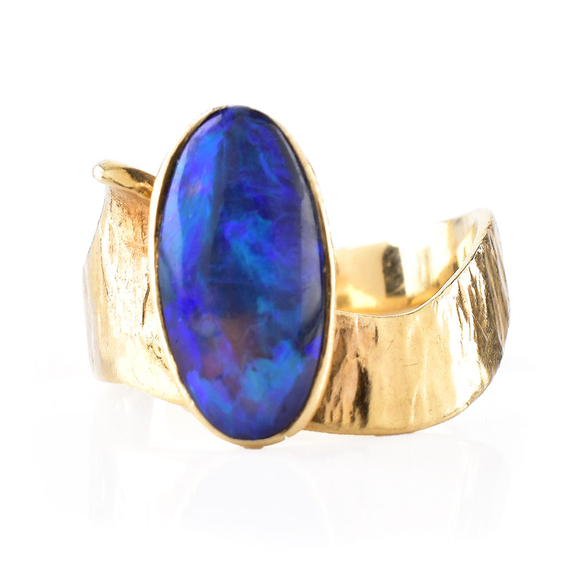 Vintage Oval Cabochon Black Opal and 14 Karat Yellow Gold Ring. Opal measures 12mm x 6.5mm.