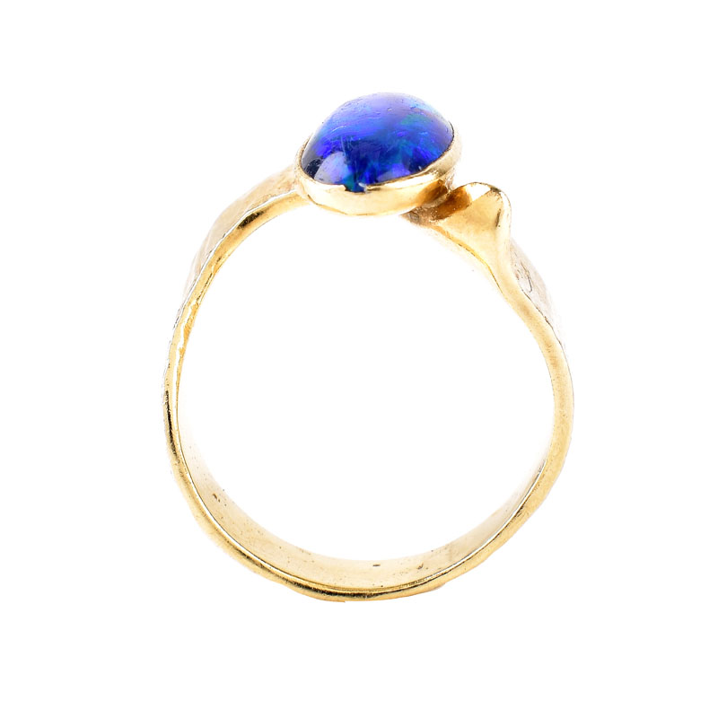 Vintage Oval Cabochon Black Opal and 14 Karat Yellow Gold Ring. Opal measures 12mm x 6.5mm.