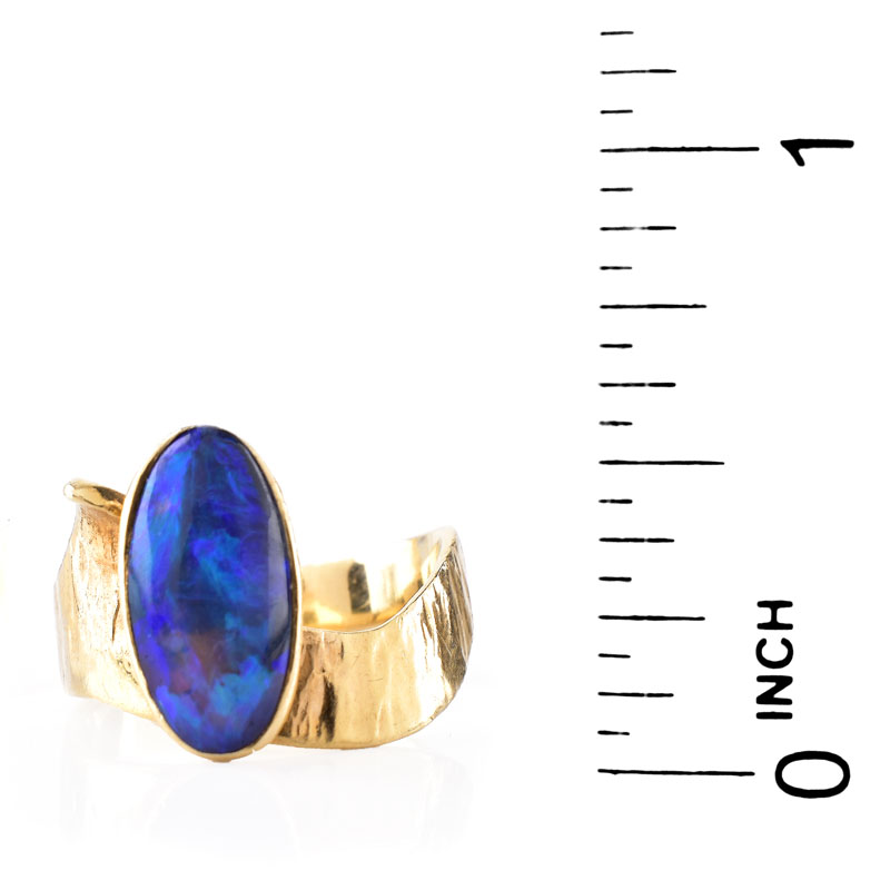 Vintage Oval Cabochon Black Opal and 14 Karat Yellow Gold Ring. Opal measures 12mm x 6.5mm.