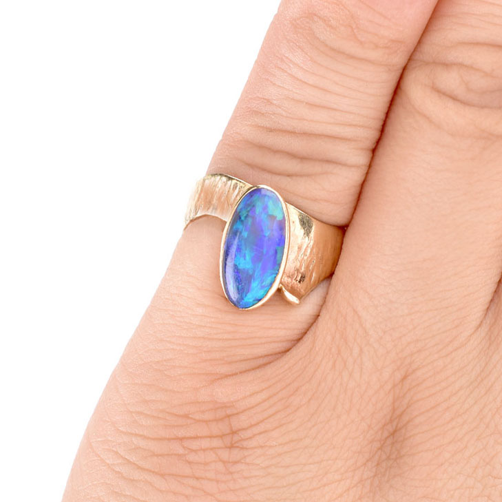 Vintage Oval Cabochon Black Opal and 14 Karat Yellow Gold Ring. Opal measures 12mm x 6.5mm.
