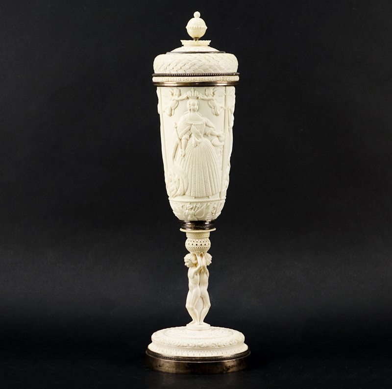 Impressive Early 19th Century Russian Imperial Carved Ivory And Silver Mounted Figural Vase And Cover. The circular base  with male figures supporting a tapered cylindrical vase carved in relief with Peter The Great and Anna Ioannovna.