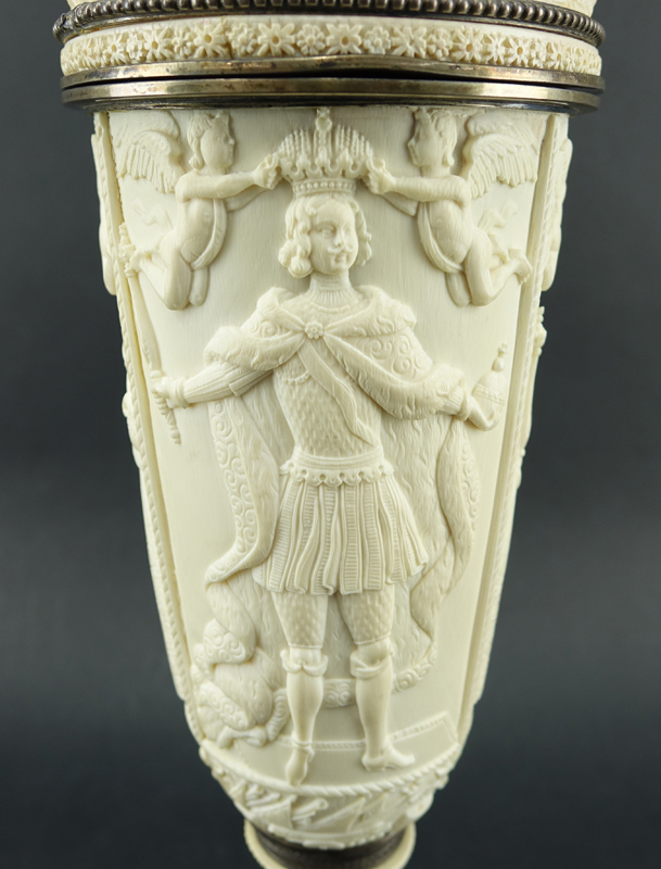 Impressive Early 19th Century Russian Imperial Carved Ivory And Silver Mounted Figural Vase And Cover. The circular base  with male figures supporting a tapered cylindrical vase carved in relief with Peter The Great and Anna Ioannovna.