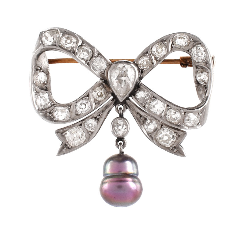 Antique Approx. 4.50 Carat Old European Cut Diamond, Baroque Pearl and Silver Topped 14 Karat Yellow Gold Bow Brooch. 