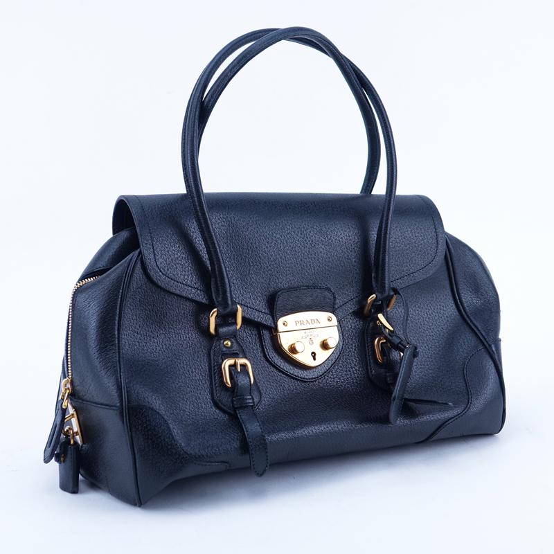 Prada Black Leather Handbag. Gold-tone hardware. Original ID tag. Lock & Keys in clouchette. Prada fabric interior.