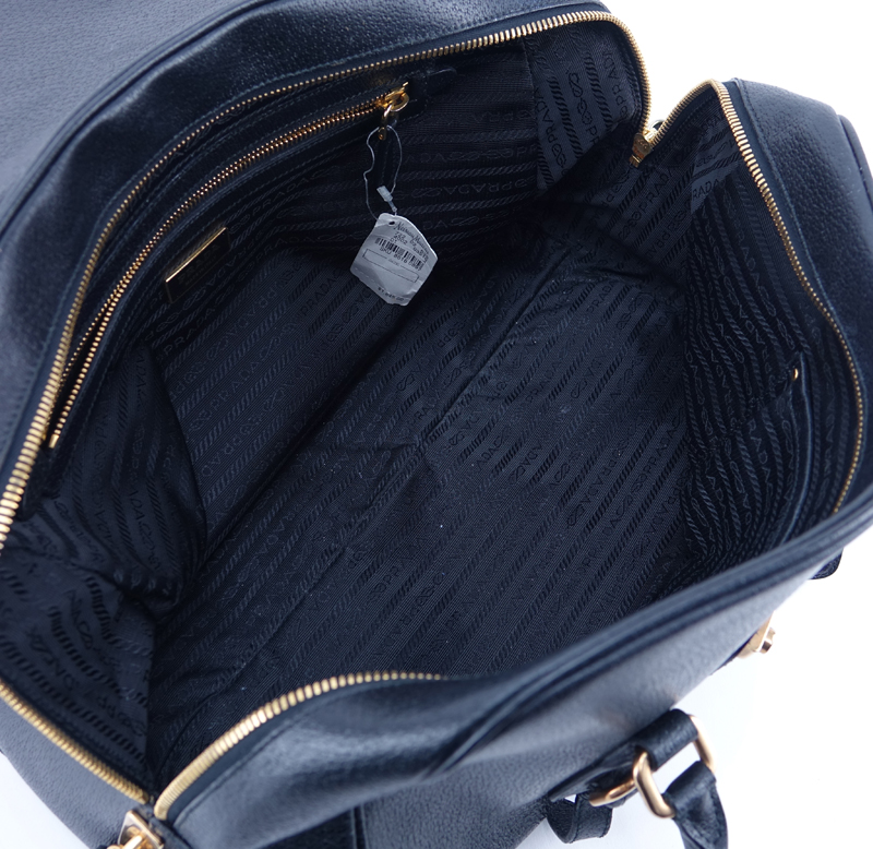 Prada Black Leather Handbag. Gold-tone hardware. Original ID tag. Lock & Keys in clouchette. Prada fabric interior.