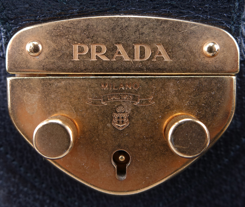 Prada Black Leather Handbag. Gold-tone hardware. Original ID tag. Lock & Keys in clouchette. Prada fabric interior.