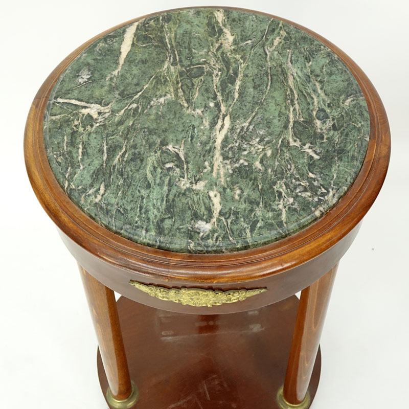 20th Century Empire Style Round Marble Top Table. Gilt brass mounted with four columns and stands on paw feet.