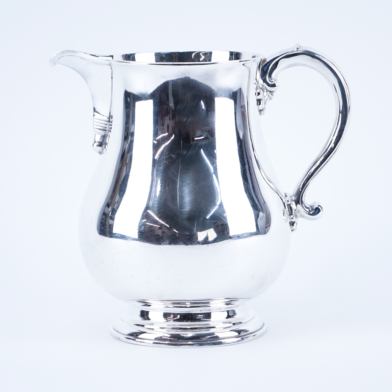 The Goldsmith & Silversmiths Co. English Silver Water Pitcher. Signed and dated London 1935.