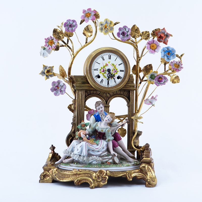 20th Century Gilt Brass and Porcelain Figural Mantle Clock. Blue stamp mark on underside of the figurine, clock unsigned. 