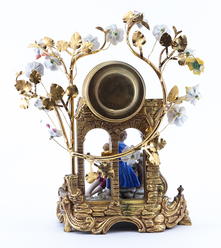 20th Century Gilt Brass and Porcelain Figural Mantle Clock. Blue stamp mark on underside of the figurine, clock unsigned. 