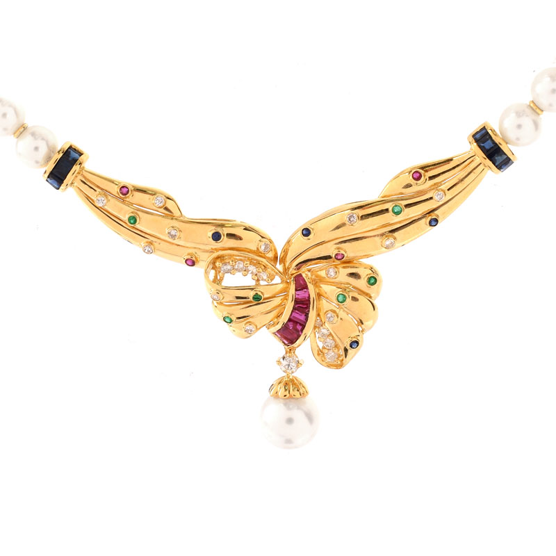 Vintage 18 Karat Yellow Gold and Pearl Pendant Necklace Accented Throughout with Round Brilliant Cut Diamonds, Rubies, Emerald and Sapphires. 