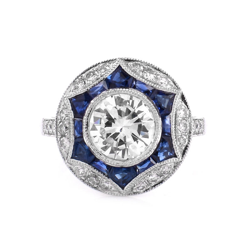 Art Deco style Approx. 1.20 Carat TW Diamond, .64 Carat Sapphire and Platinum Ring set in the Center with a .97 Carat Round Brilliant Cut Diamond. 