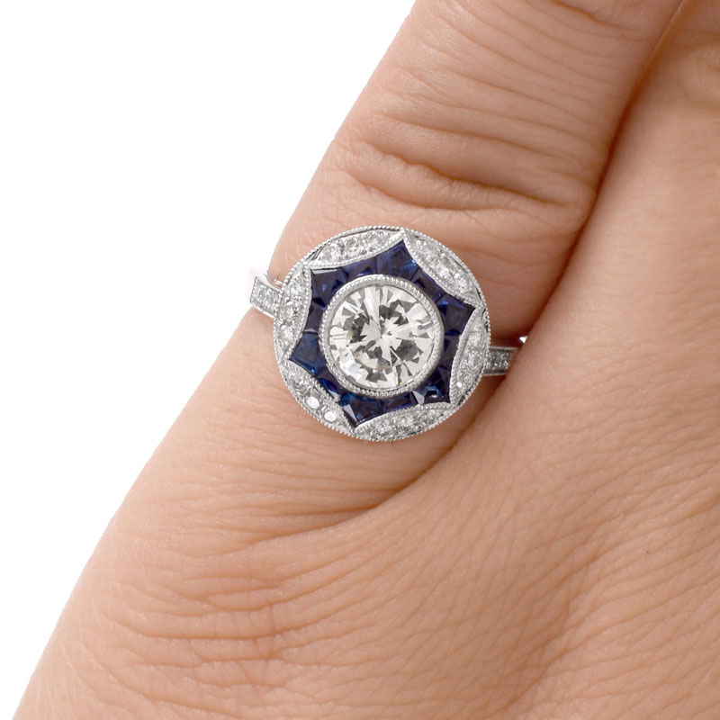 Art Deco style Approx. 1.20 Carat TW Diamond, .64 Carat Sapphire and Platinum Ring set in the Center with a .97 Carat Round Brilliant Cut Diamond. 