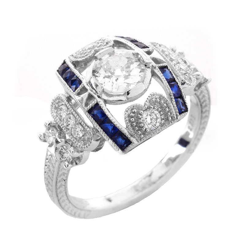 Art Deco style Approx. .86 Carat TW Diamond, .38 Carat Sapphire and Platinum Ring set in the Center with a .55 Carat Round Brilliant Cut Diamond. 