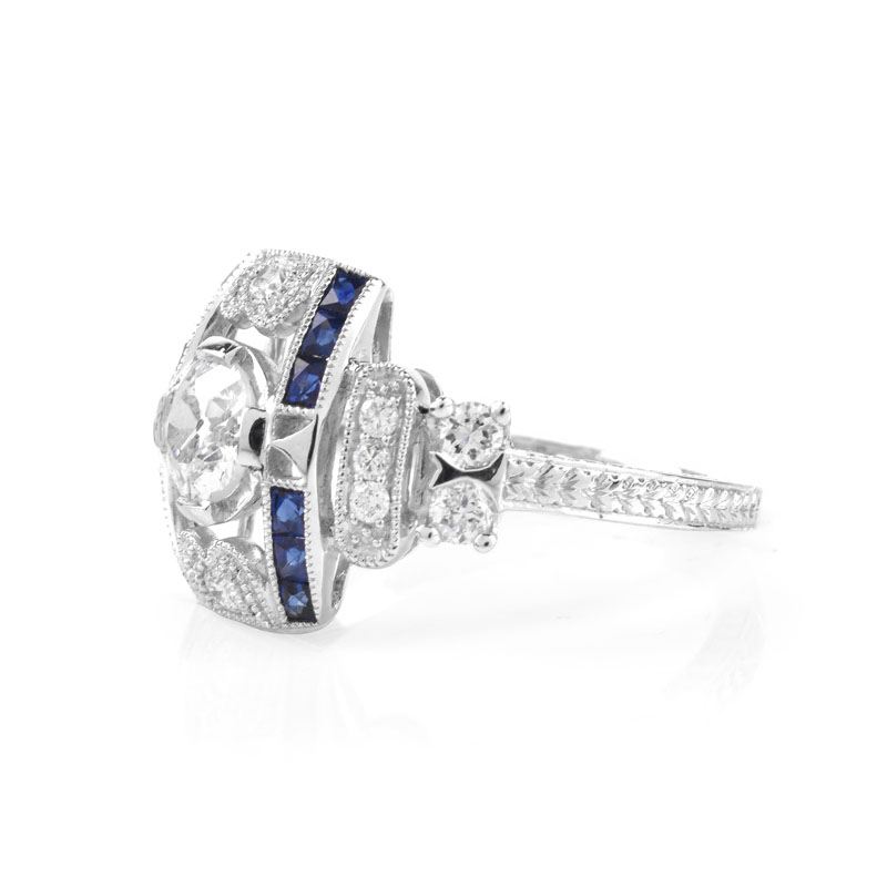 Art Deco style Approx. .86 Carat TW Diamond, .38 Carat Sapphire and Platinum Ring set in the Center with a .55 Carat Round Brilliant Cut Diamond. 