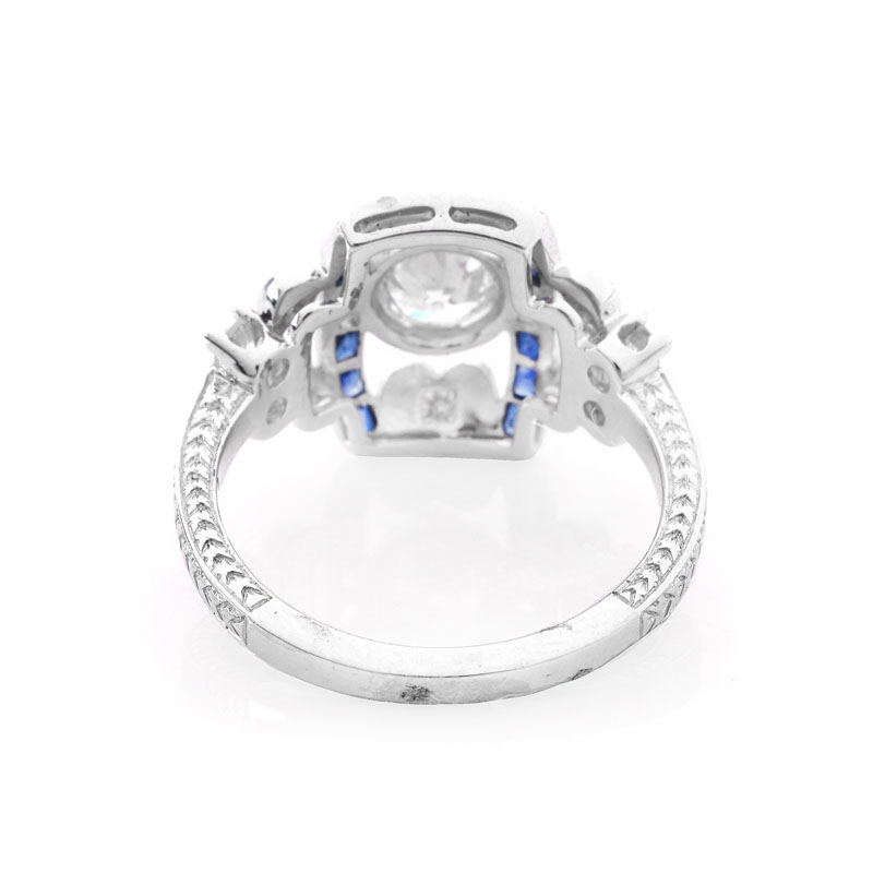 Art Deco style Approx. .86 Carat TW Diamond, .38 Carat Sapphire and Platinum Ring set in the Center with a .55 Carat Round Brilliant Cut Diamond. 