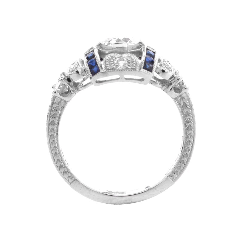 Art Deco style Approx. .86 Carat TW Diamond, .38 Carat Sapphire and Platinum Ring set in the Center with a .55 Carat Round Brilliant Cut Diamond. 