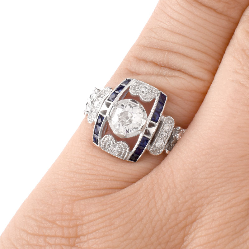 Art Deco style Approx. .86 Carat TW Diamond, .38 Carat Sapphire and Platinum Ring set in the Center with a .55 Carat Round Brilliant Cut Diamond. 