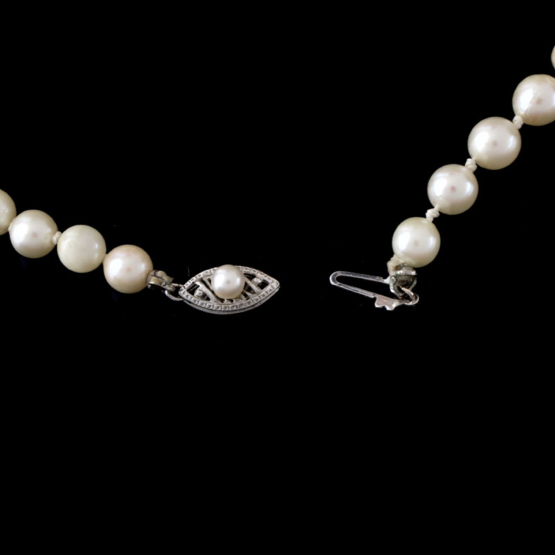 Antique Single Strand Ninety One (91) Graduated White Pearl Necklace with 14 Karat White Gold Clasp.