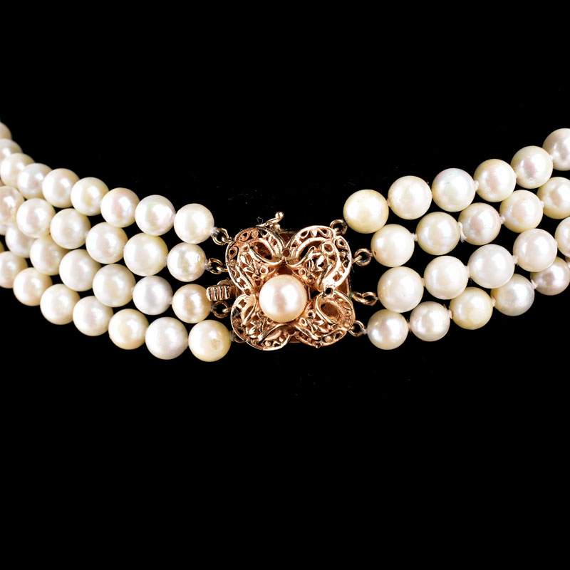 Vintage Four Strand 8mm White Pearl and 14 Karat Yellow Gold Necklace. Stamped 14K to clasp, Pearls with good polish and luster. 