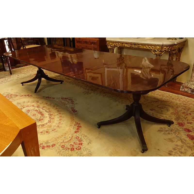 Large 19th Century Sheraton Mahogany Dinning Table. Carved urn pedestal with three sweeps and brass paw form terminals on Wheels.